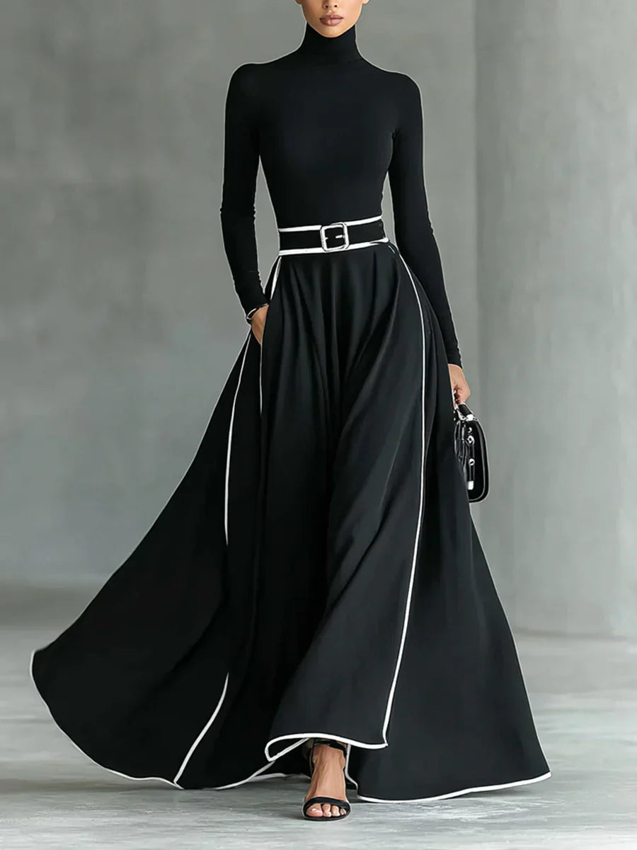 Adriana - Vestido largo negro con costuras blancas, cuello alto y cinturón ajustado