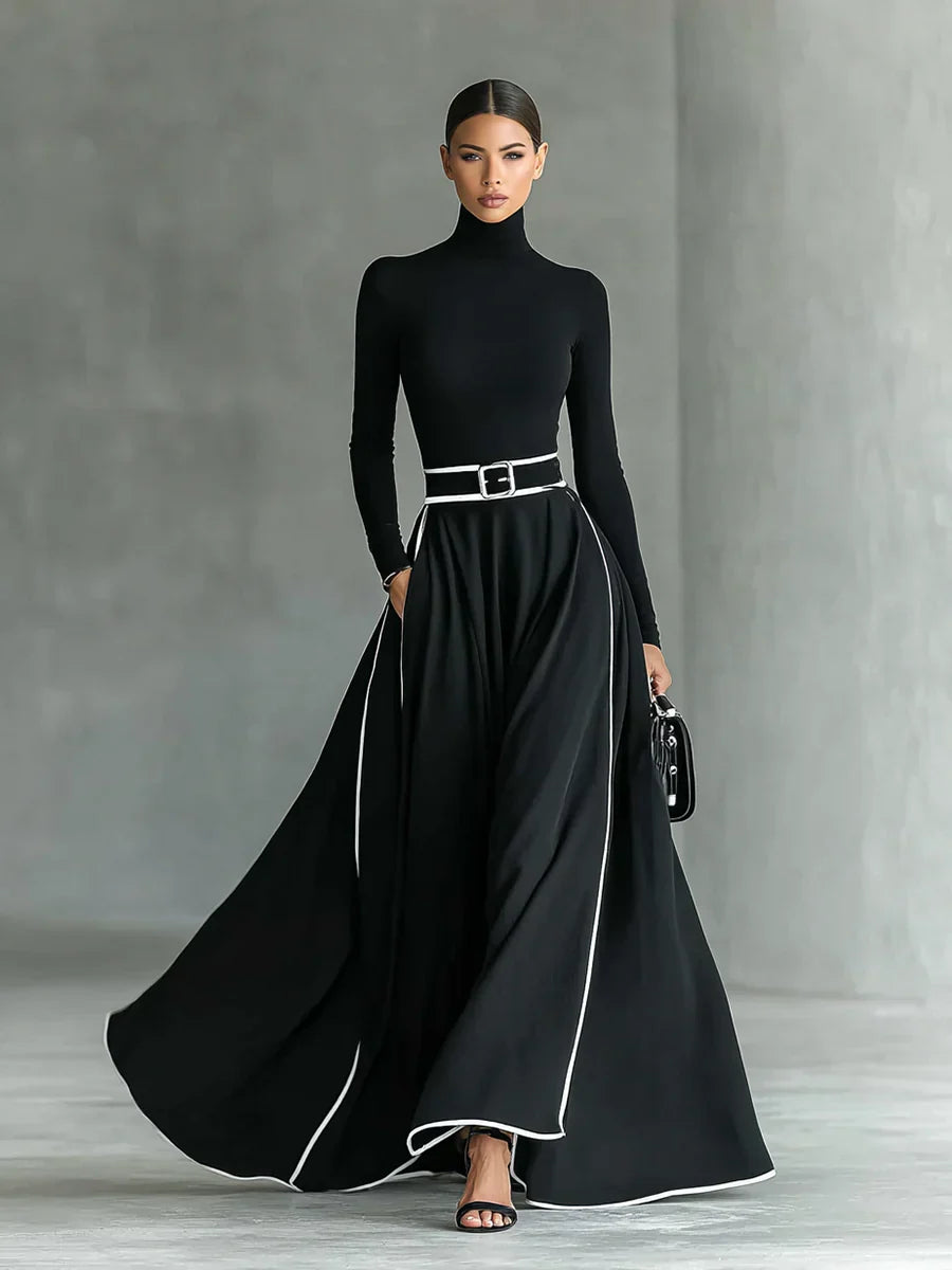 Adriana - Vestido largo negro con costuras blancas, cuello alto y cinturón ajustado